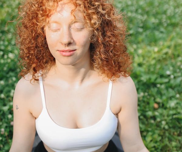 Woman feeling energized and happy after a yoga session, outdoors.